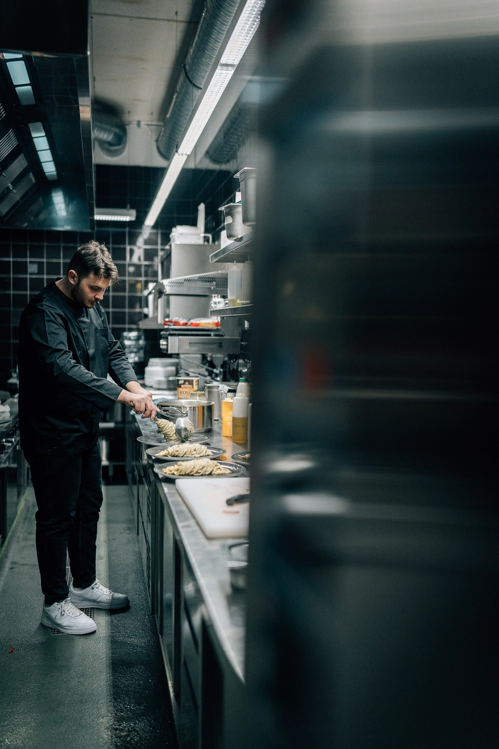 Sinn Kitchen – Restaurant – Der Koch bereitet Speisen zu.